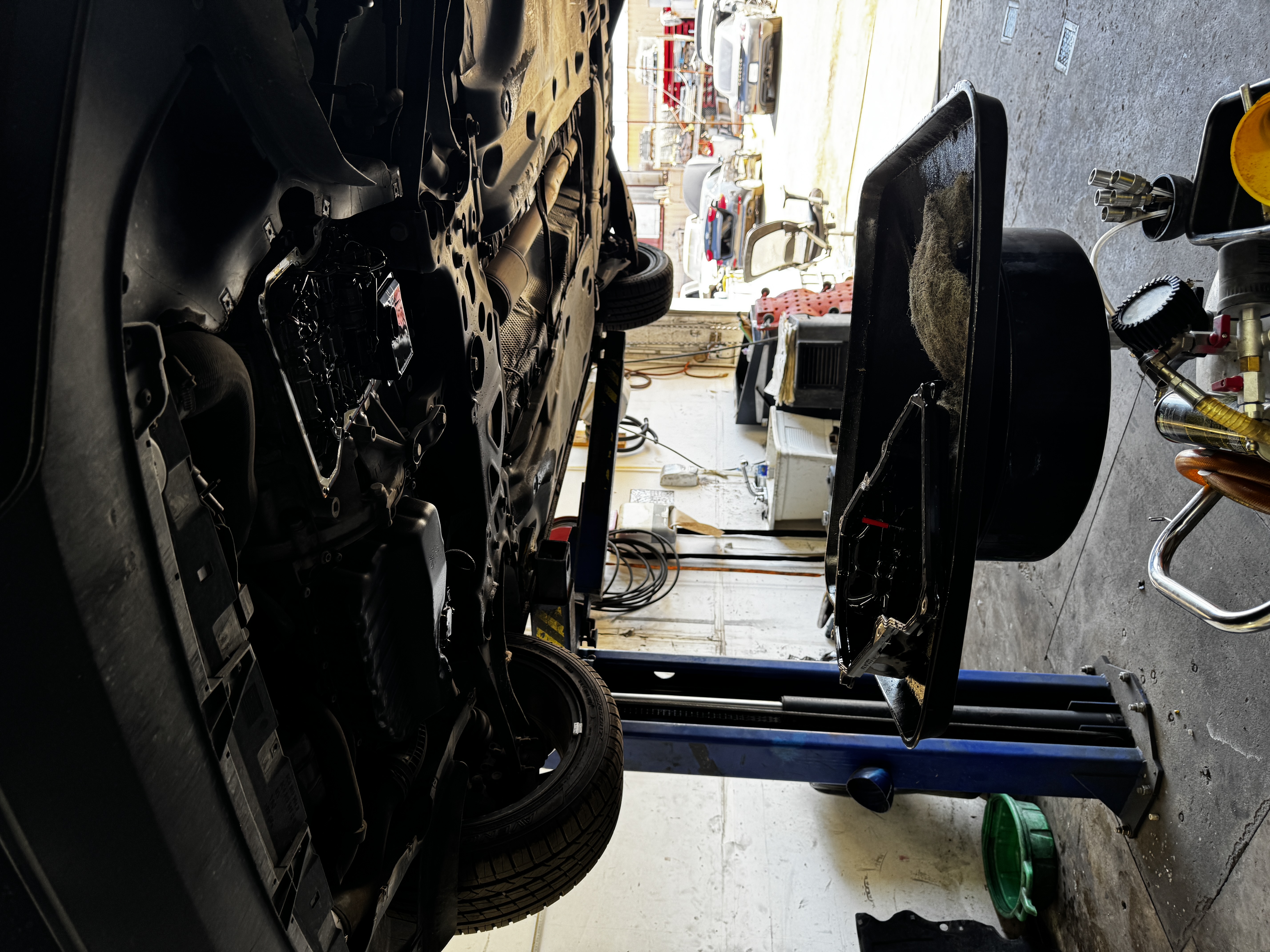 Under-engine repair work in progress.